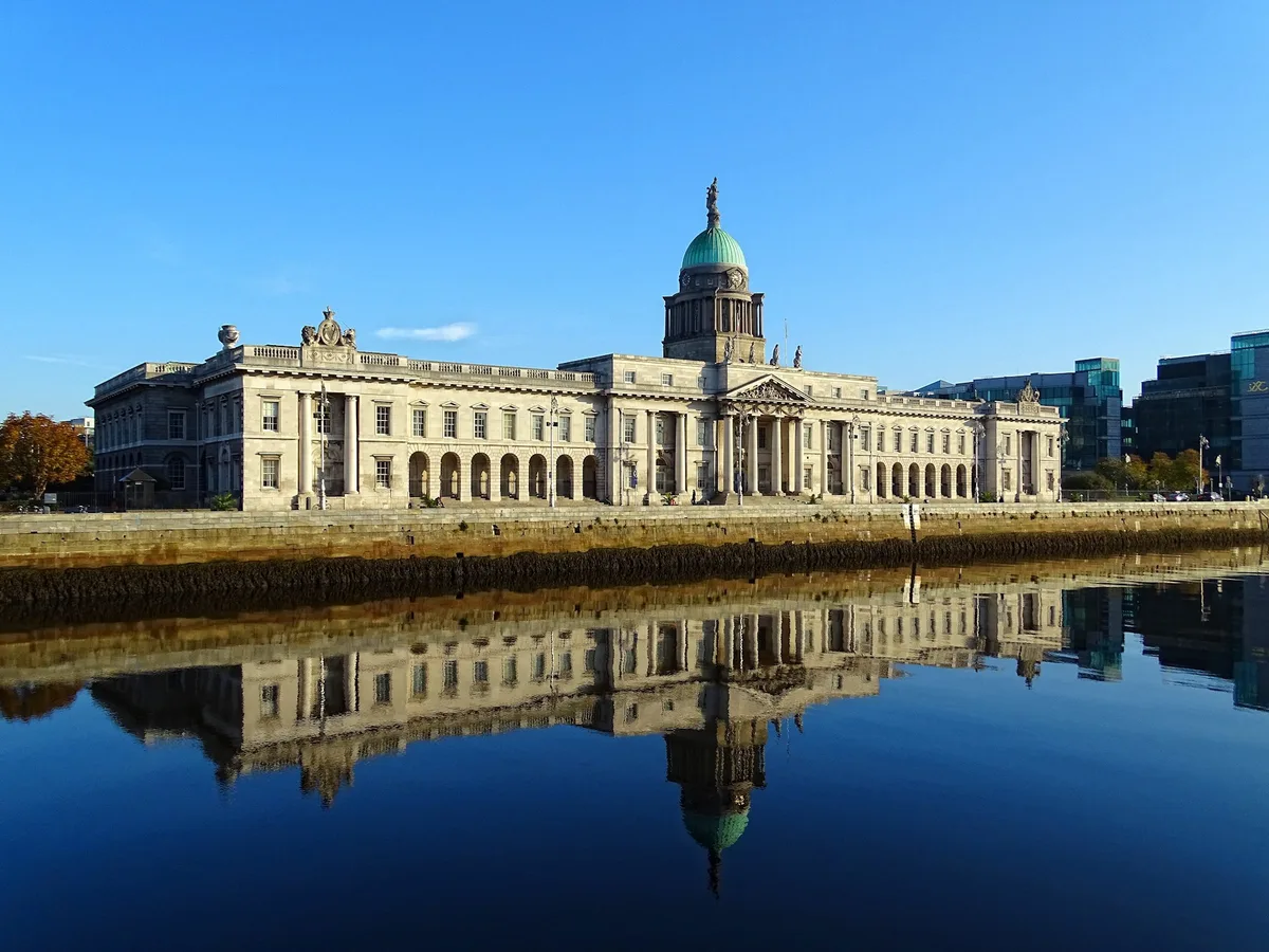 The Custom House in Dublin - A long, pale Portland-stone neoclassical block crowned by a copper dome, its river...