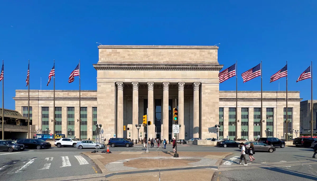 30th Street Station in Philadelphia - A vast travertine hall with fluted columns and a coffered ceiling, the concourse...