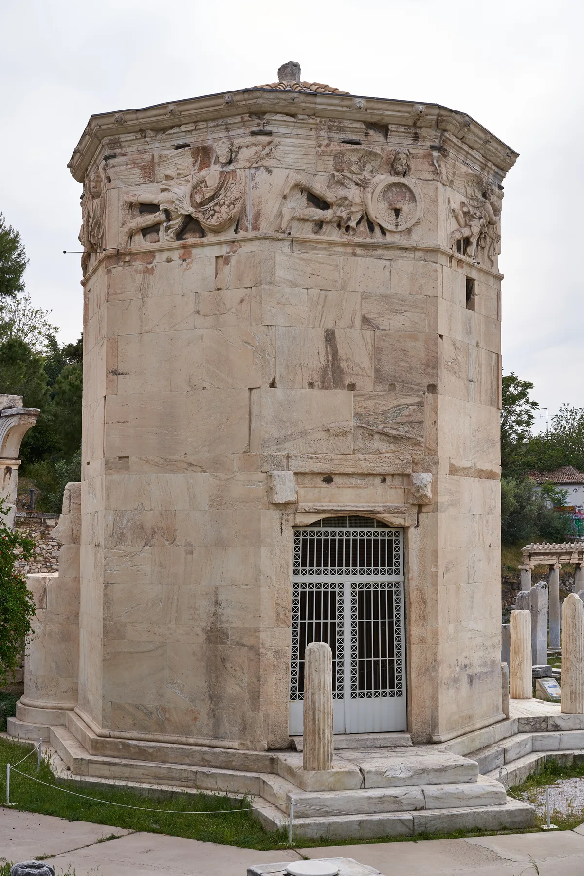 Tower of the Winds in Athens - An octagonal marble tower standing in the Roman Agora, with carved relief figures on...