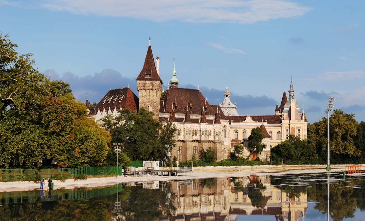 Vajdahunyad Castle in Budapest - A storybook castle rising from an island in City Park, its skyline a mix of Romanesque...