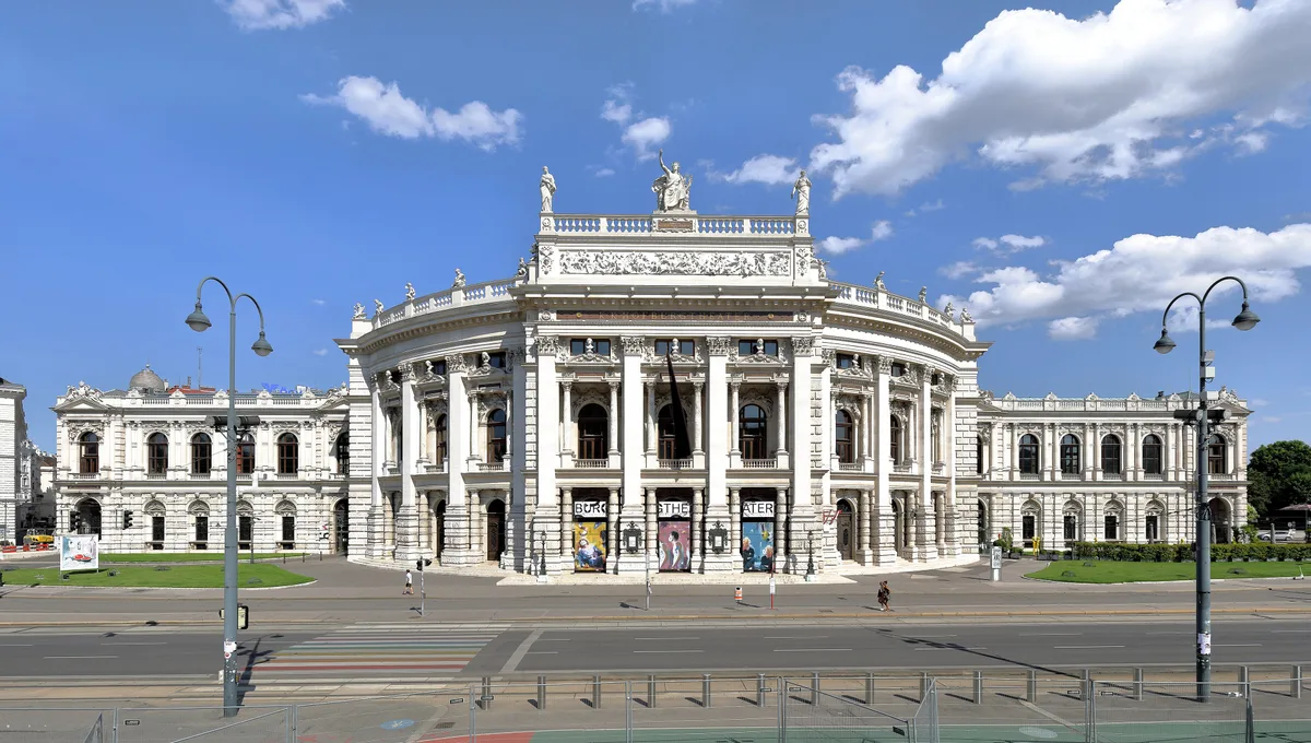 Burgtheater in Vienna - A grand neo-Baroque theatre of pale stone with a rusticated arcaded base and a sculpted attic crowned by Apollo between the Muses, fronting the Ring near the Rathaus.