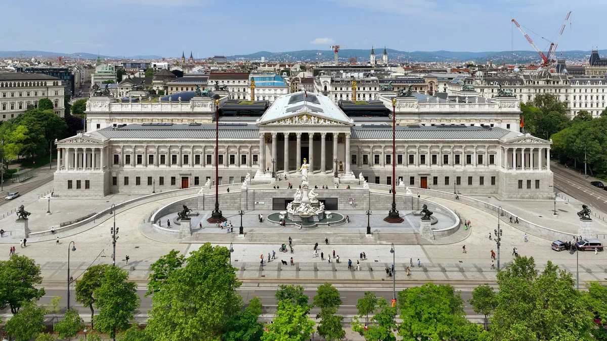 Austrian Parliament (Parlament) in Vienna - A Hellenic temple front of soaring Corinthian columns and a gilded Pallas Athene fountain, its pediment sculptures evoking ancient Athens rather than Catholic Vienna.