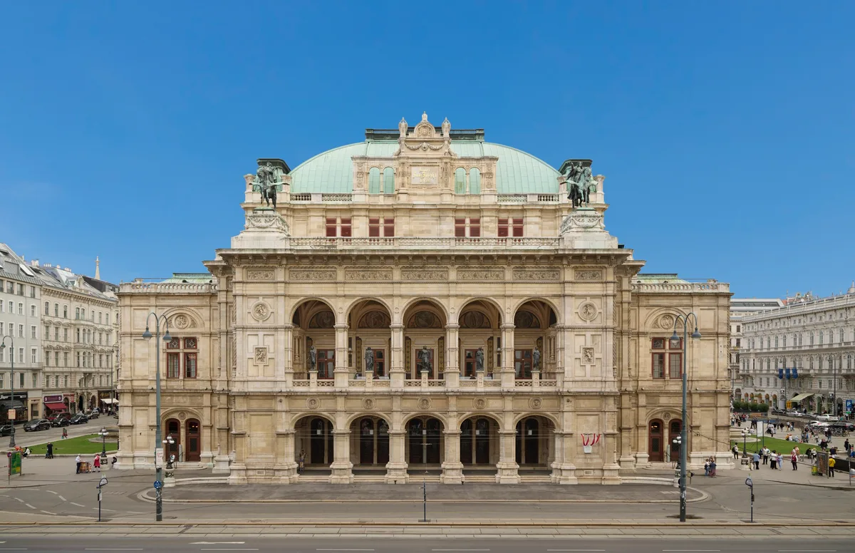 Vienna State Opera (Staatsoper) in Vienna - A grand neo-Renaissance opera house of honey-coloured stone, its arcaded facade fronting the Ring, with a row of statue groups along the attic storey.