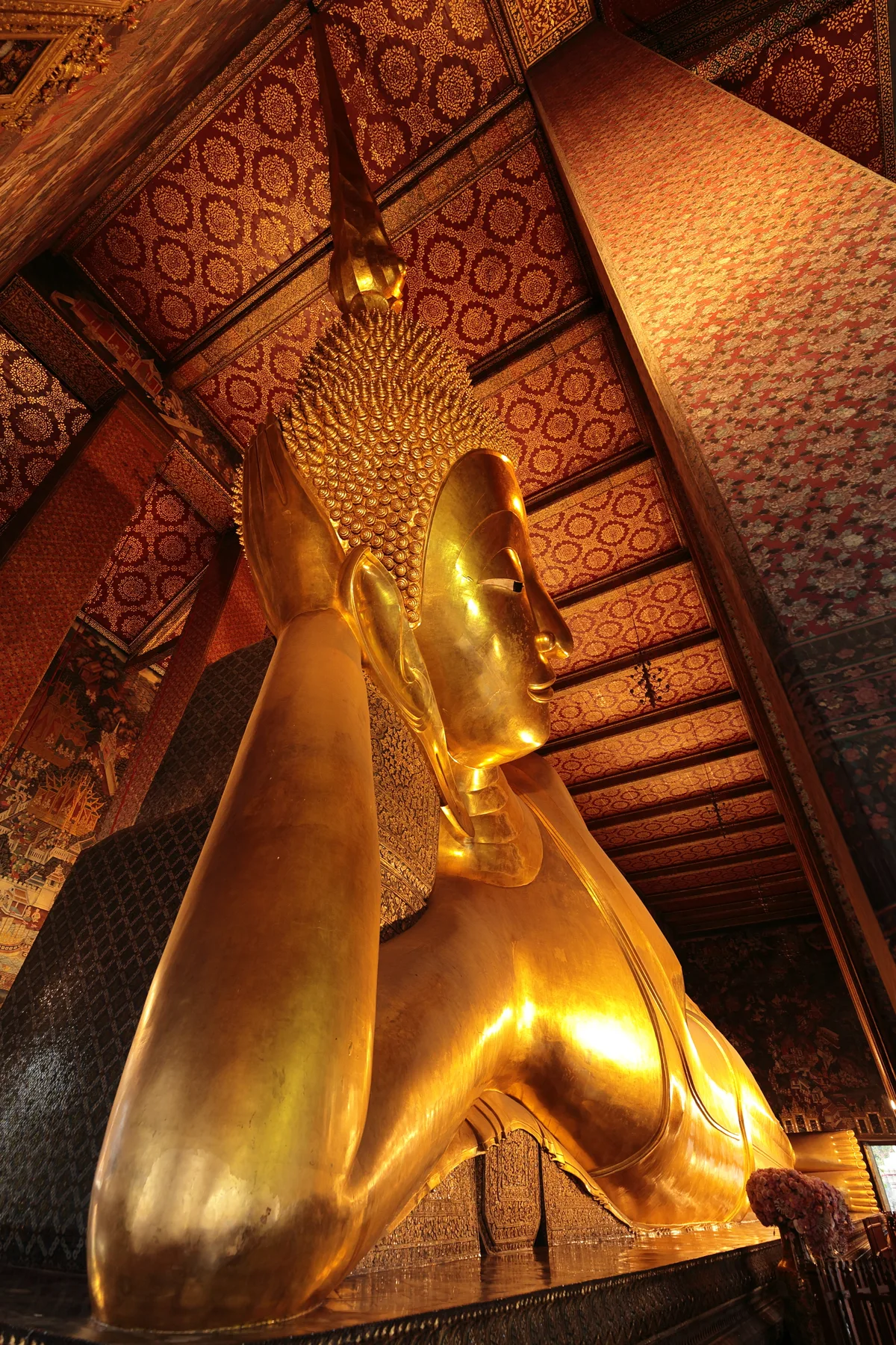 Wat Pho in Bangkok - A vast temple complex housing a 46-metre-long gold-leaf-covered Reclining Buddha that fills an...