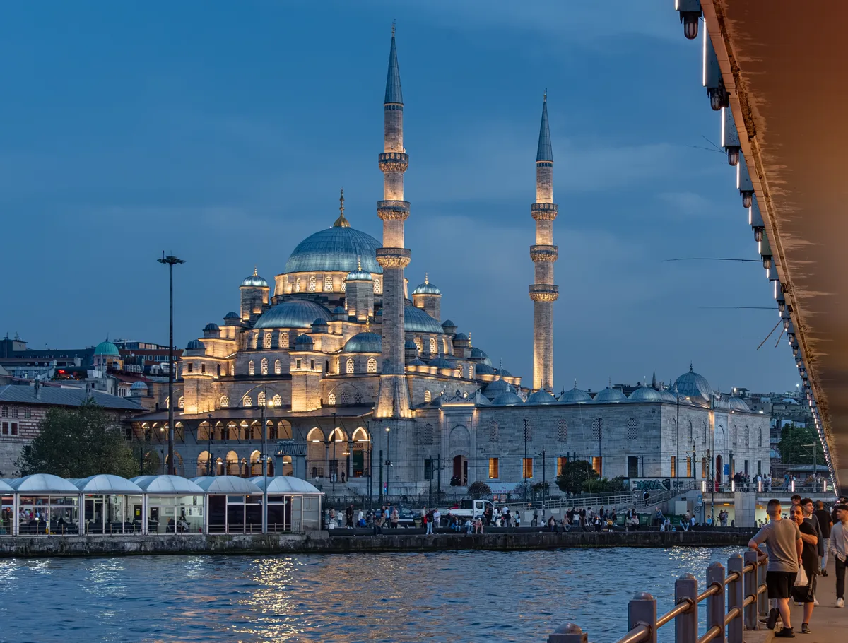 New Mosque in Istanbul - A large courtyard mosque with two tall minarets and cascading domes, located at the foot of...